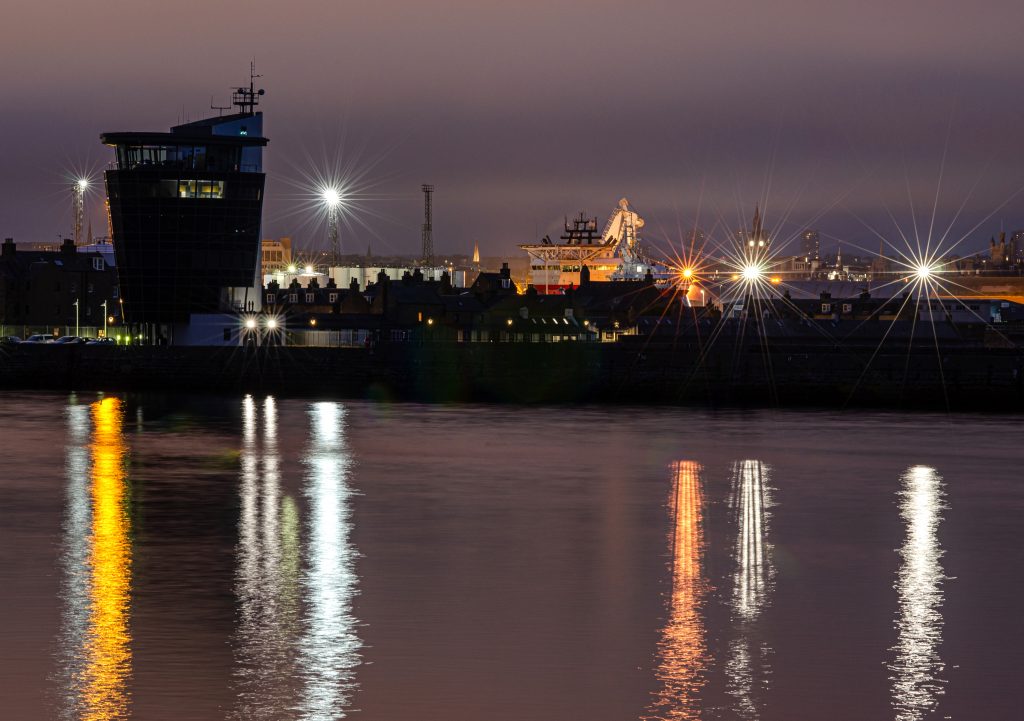 Nighttime Aberdeen Harbour showing harbour lights from Footdee reflecting in water