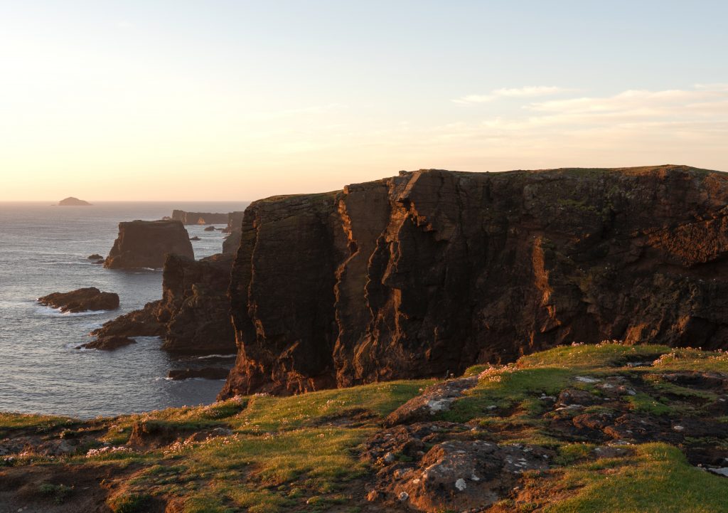 Cliffs at Eshaness, Shetland. Evening light picks out a face in the rocks