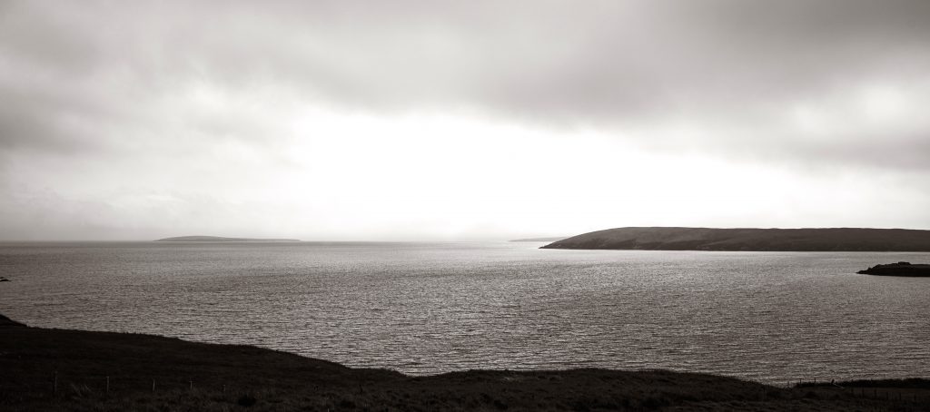 Monochrome panorama of Yell Sound and the island of Lamba from Ollaberry, Shetland