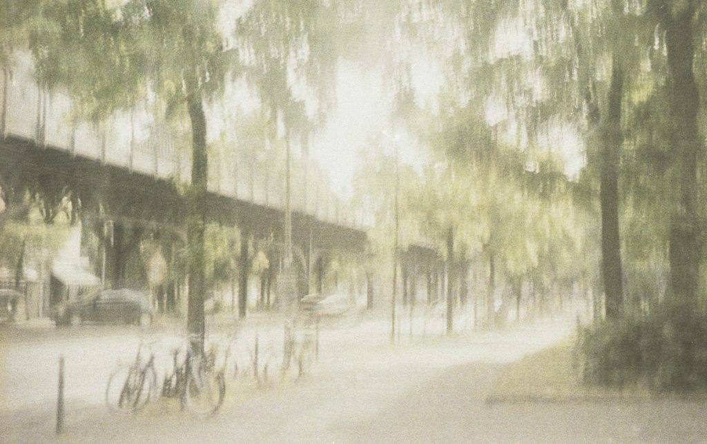A street view in Berlin with feel of a watercolour painting. Taken with a film camera, the shutter jammed producing this natural effect