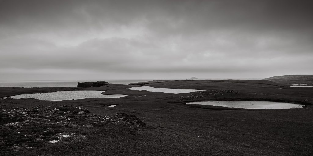 Monochrome landscape of moorland lochans on the clifftops of Eshaness in Shetland